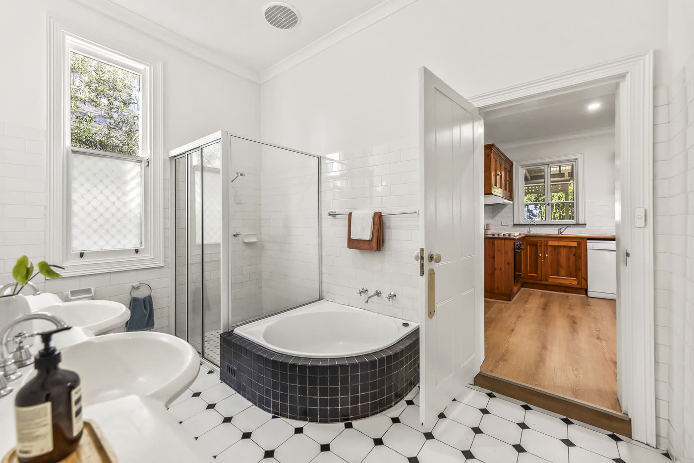 Renovated bathroom with fresh paint and new flooring beyond