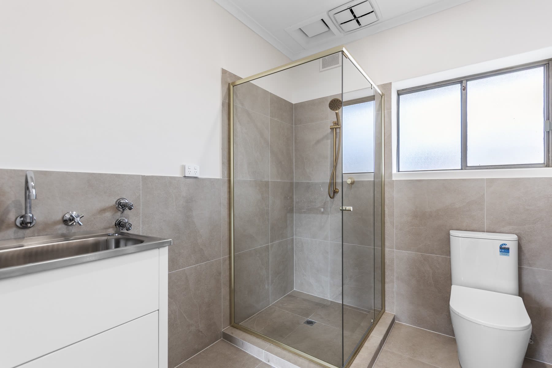 Renovated bathroom with large format tiles and new vanity
